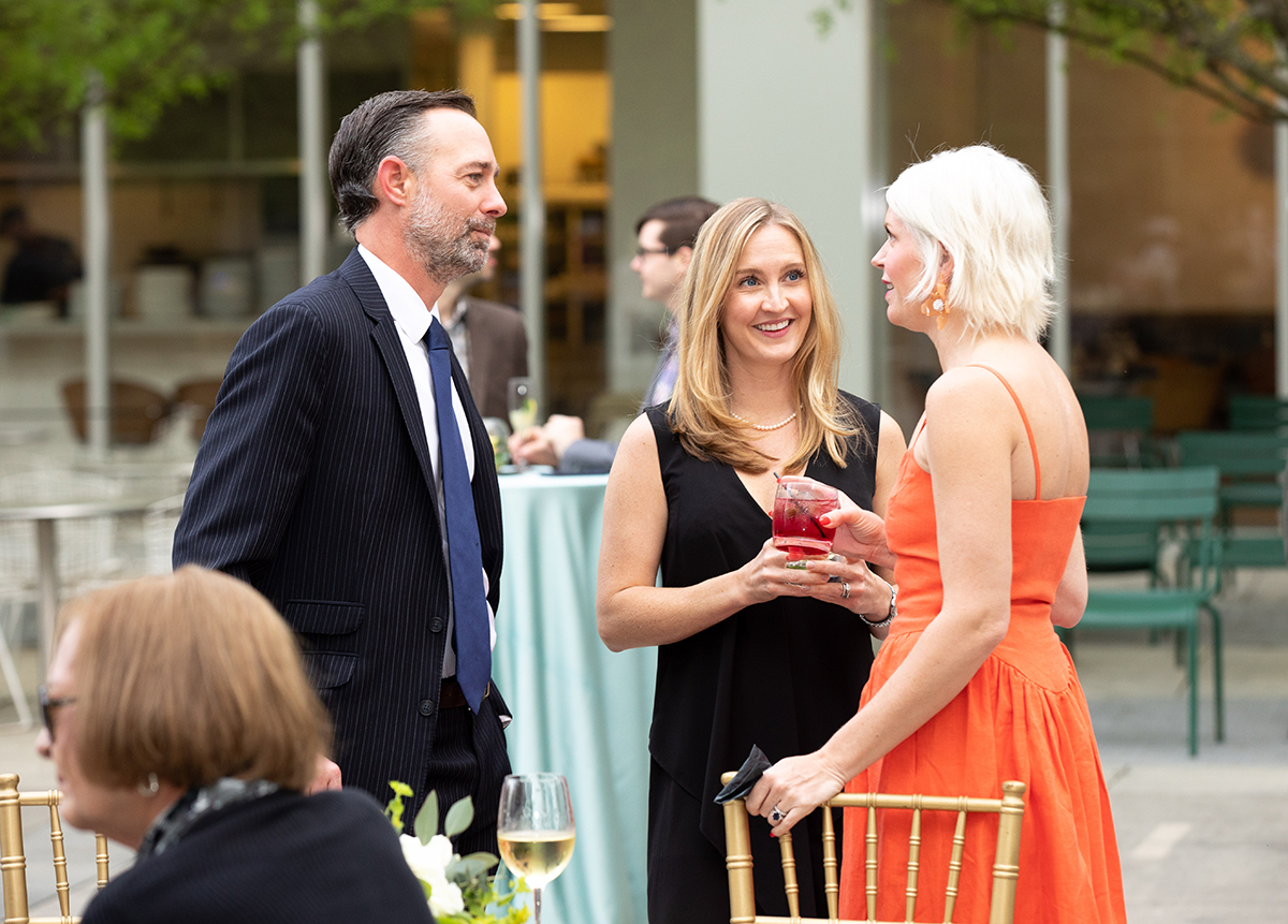 Patrons mingle at a party in the Piazza