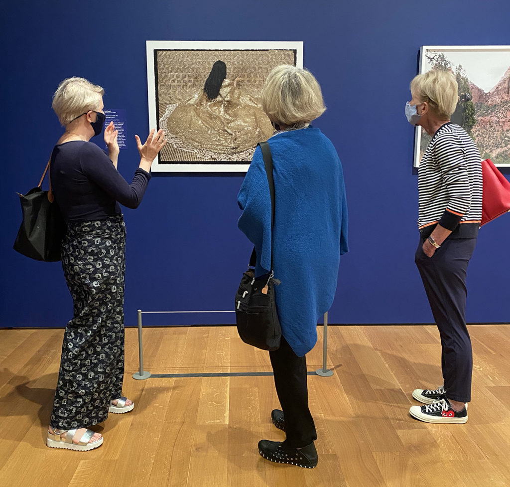 Members view artwork in the Underexposed exhibition