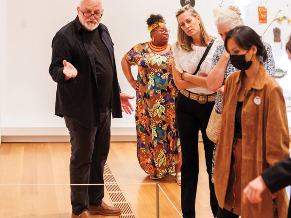 A docent leads a tour in a gallery.